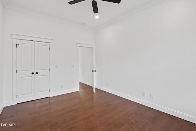 unfurnished bedroom with a closet, ceiling fan, dark hardwood / wood-style flooring, and crown molding