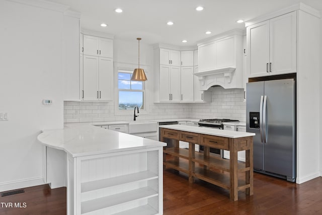 kitchen with sink, white cabinets, pendant lighting, and appliances with stainless steel finishes