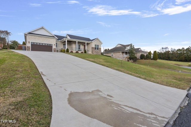 ranch-style home with a garage, covered porch, and a front yard