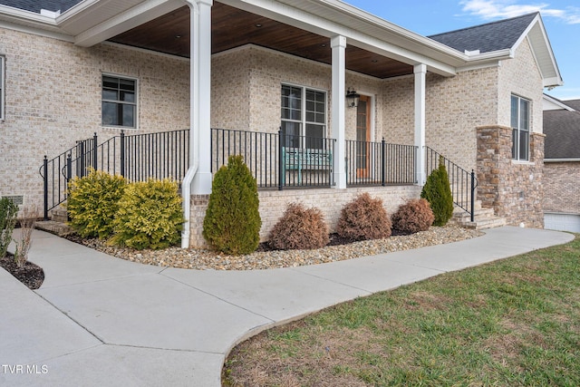 view of exterior entry with covered porch