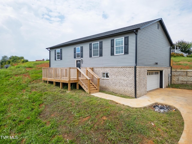 view of front of home featuring a garage and a wooden deck