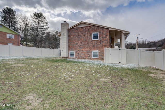 view of side of property with a yard