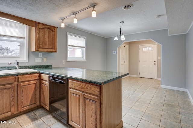 kitchen with dishwasher, light tile patterned floors, a textured ceiling, and sink