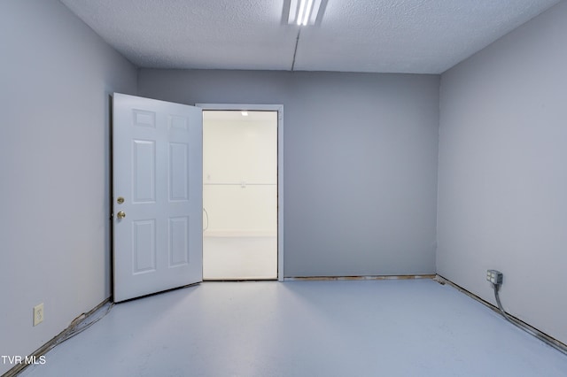 empty room with a textured ceiling