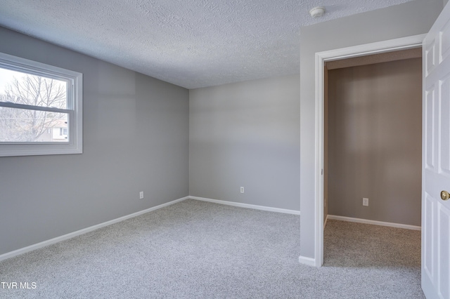 unfurnished bedroom featuring light colored carpet and a textured ceiling