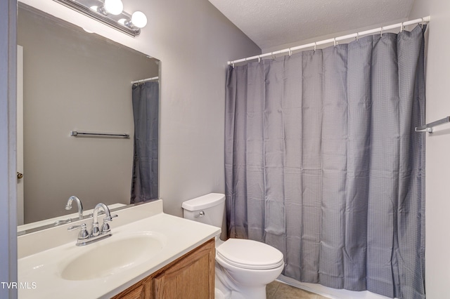 bathroom with vanity, tile patterned floors, a textured ceiling, and toilet