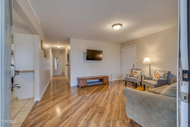 living room featuring a textured ceiling and light hardwood / wood-style floors