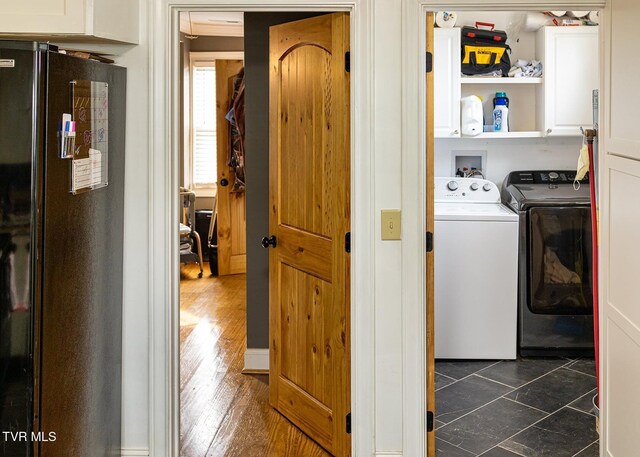 washroom with washing machine and clothes dryer and cabinets