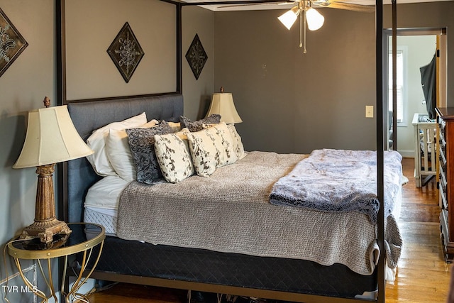 bedroom with wood-type flooring and ceiling fan