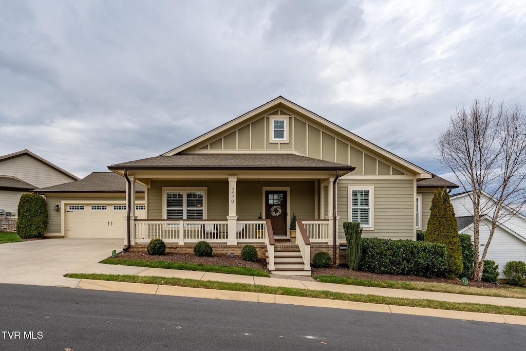 view of front of house featuring a porch and a garage