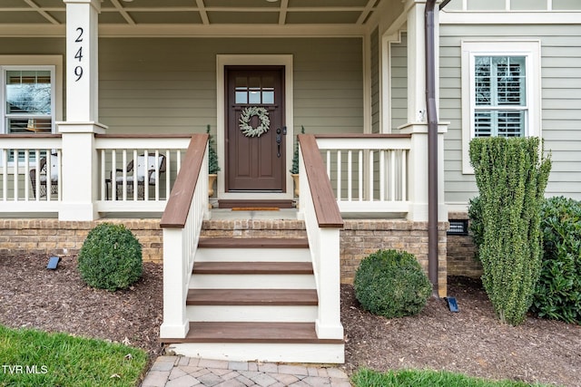 entrance to property featuring a porch