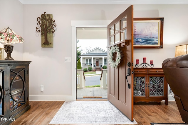 entryway with hardwood / wood-style floors