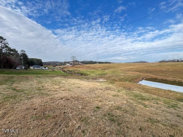 view of yard with a rural view and a water view