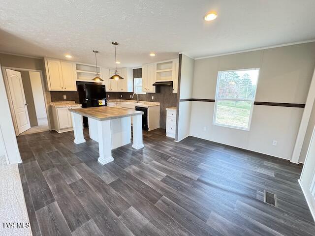 kitchen with white cabinets, pendant lighting, dark hardwood / wood-style floors, and a kitchen island