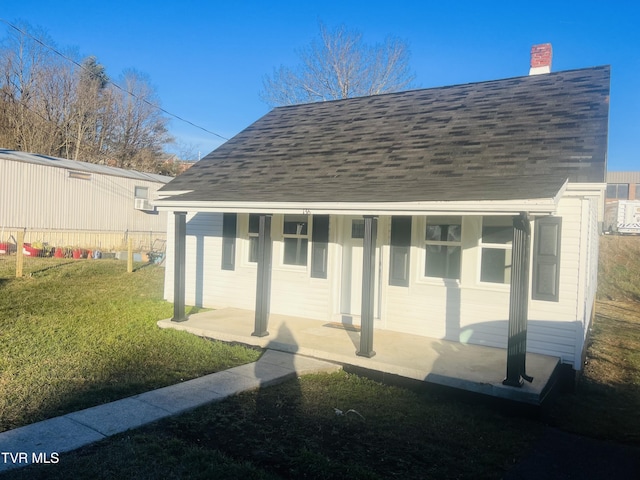 back of property featuring a yard