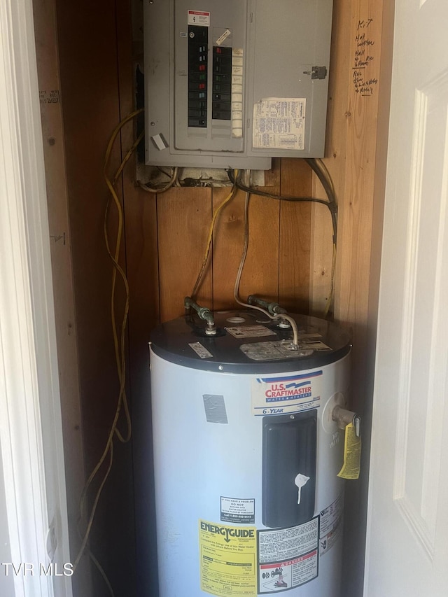 utility room featuring electric water heater and electric panel