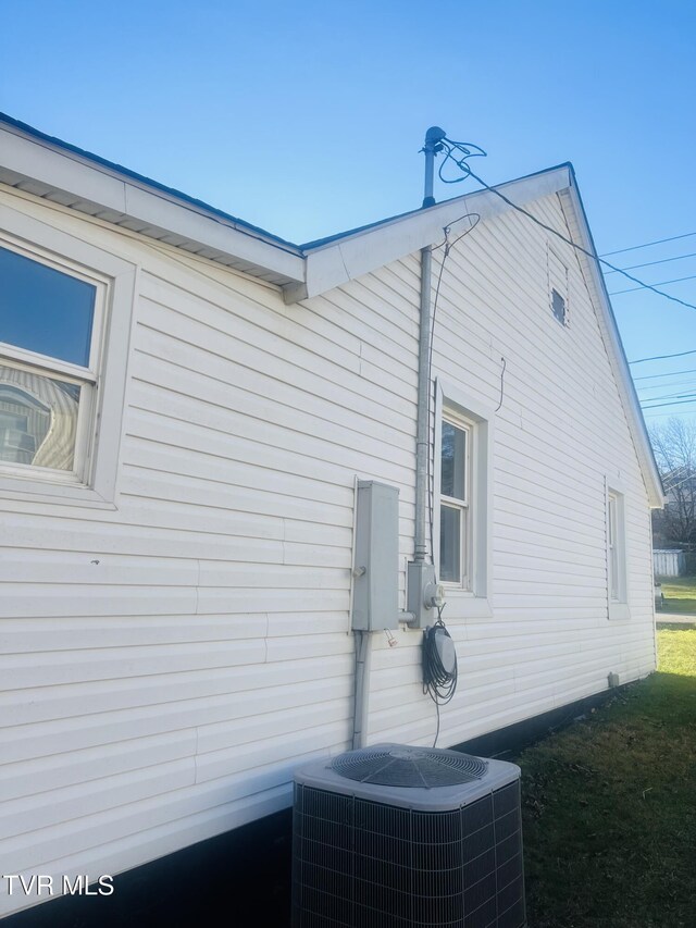 view of side of home with central air condition unit