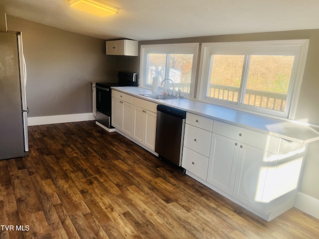 kitchen with white cabinets, stainless steel appliances, dark hardwood / wood-style floors, and sink