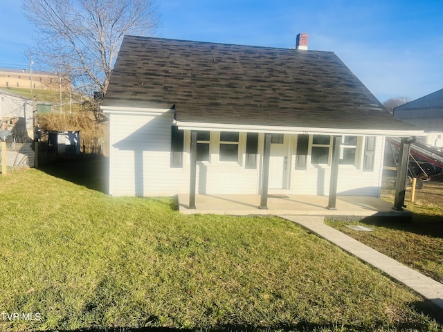 rear view of house with a lawn