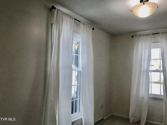 empty room featuring a baseboard heating unit