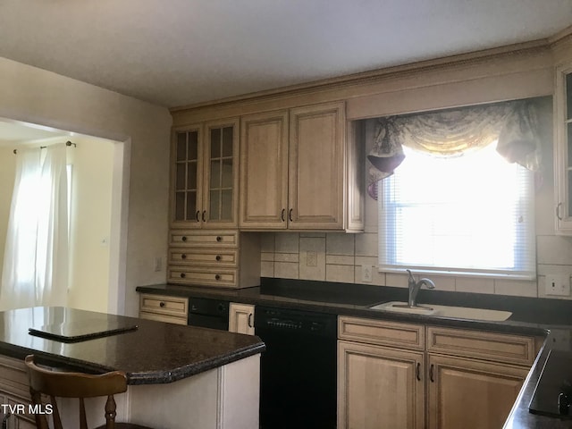 kitchen with decorative backsplash, a sink, black dishwasher, dark countertops, and glass insert cabinets