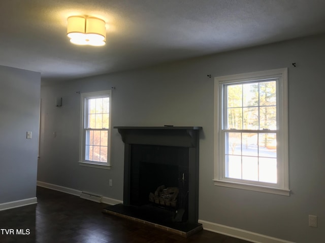 unfurnished living room featuring baseboards, visible vents, and a fireplace with raised hearth