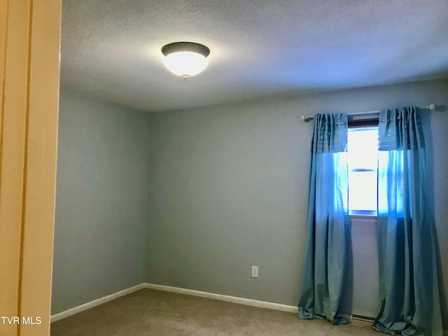 unfurnished room featuring a textured ceiling and carpet flooring