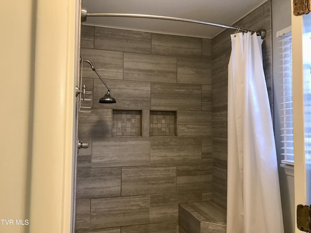 full bath featuring tiled shower