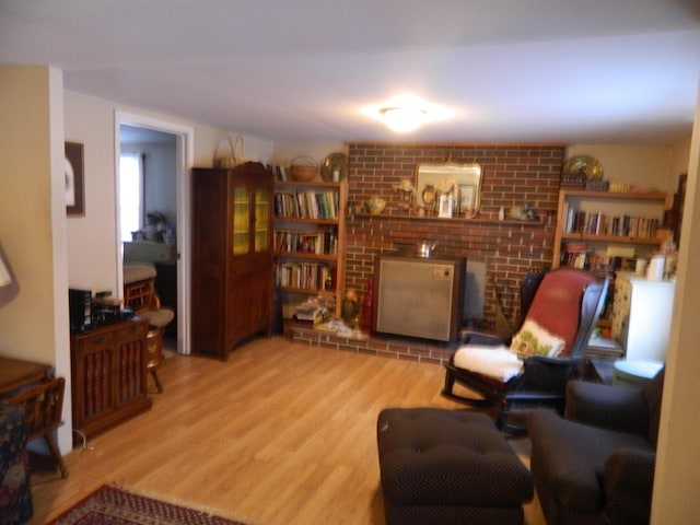 living area with light wood-type flooring and a fireplace