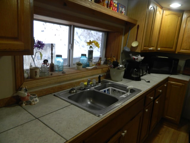 kitchen with tile counters and sink