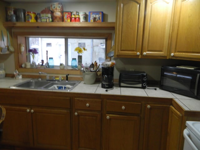 kitchen with tile countertops and sink