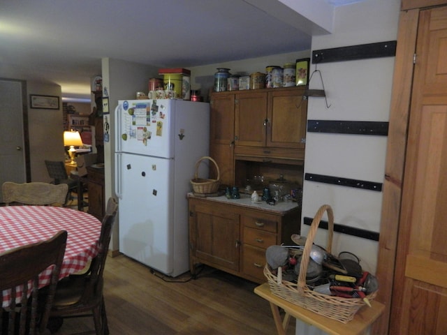 kitchen with white refrigerator and dark hardwood / wood-style floors