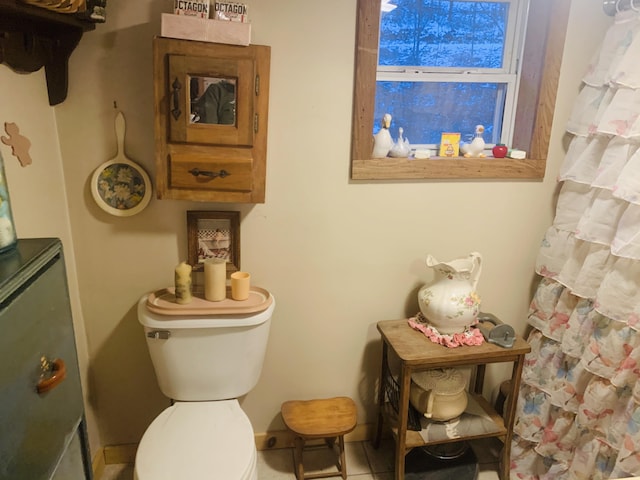 bathroom with tile patterned flooring and toilet