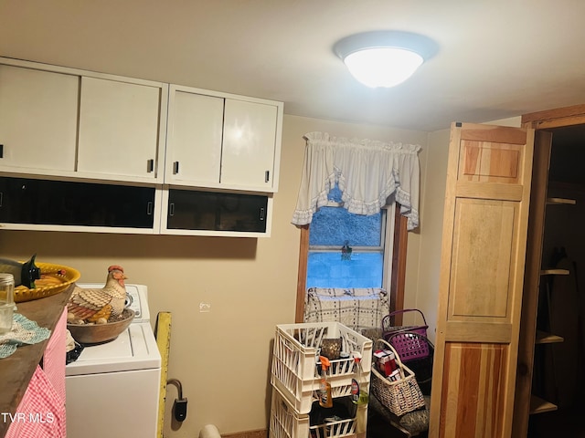 washroom featuring washer / clothes dryer and cabinets