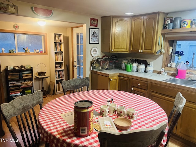 dining room featuring sink and light hardwood / wood-style flooring