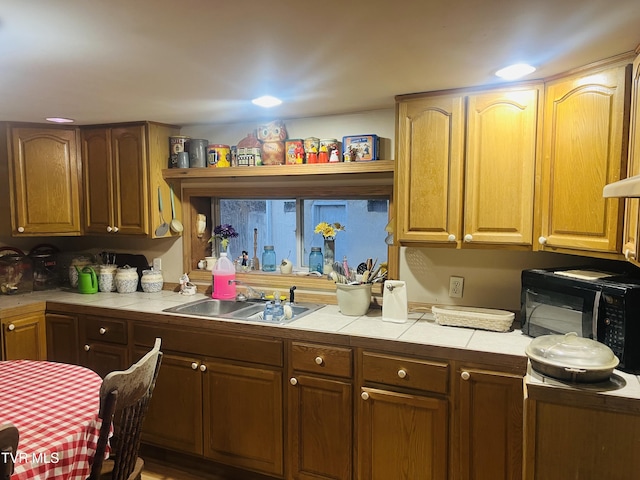 kitchen featuring tile counters and sink