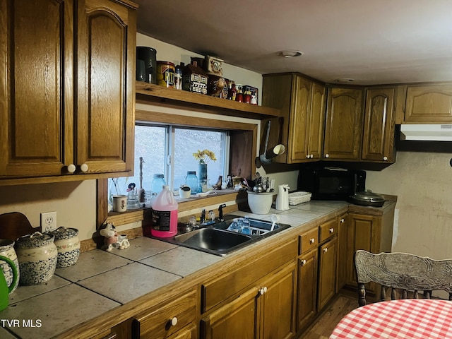 kitchen with tile countertops and sink