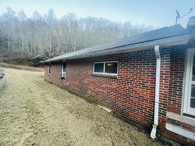 view of side of home featuring cooling unit