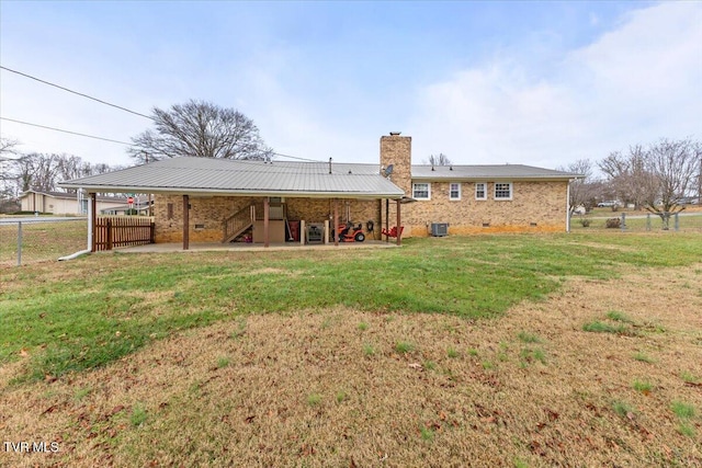 rear view of property featuring a yard, a patio, and central AC unit