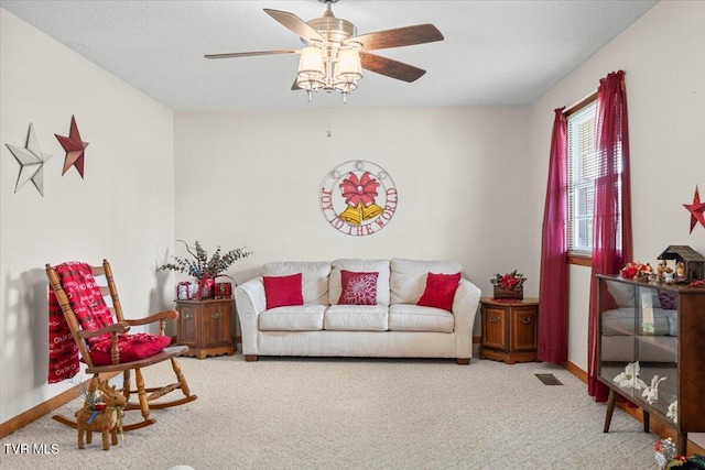 living room featuring carpet and ceiling fan