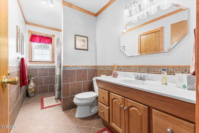 bathroom featuring vanity, tile patterned floors, crown molding, toilet, and tile walls