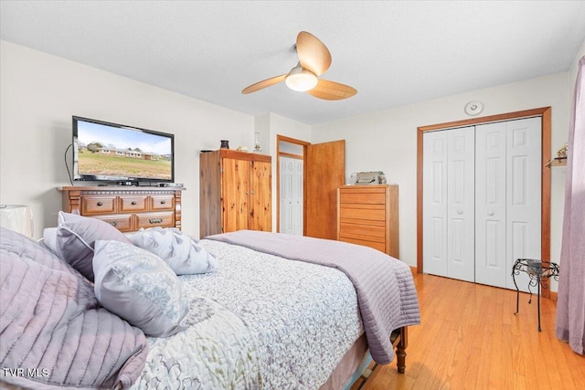 bedroom featuring ceiling fan, a closet, and light wood-type flooring