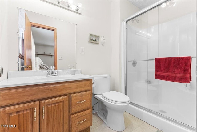 bathroom featuring vanity, toilet, and walk in shower