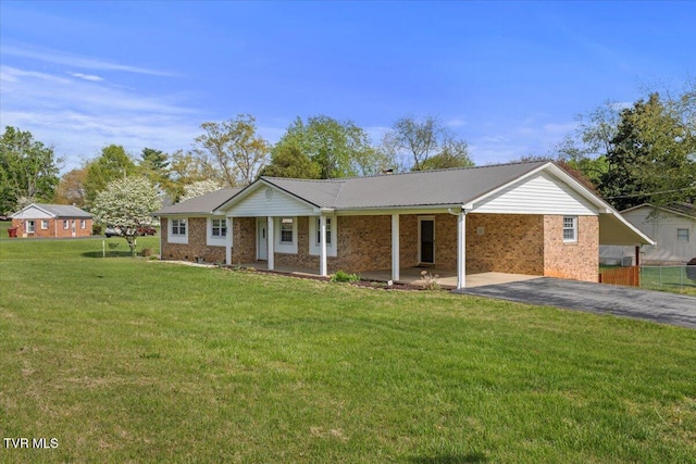 212 Mayflower Rd, Johnson City, TN 37601 - ranch-style house with a front lawn, a carport, a porch, brick siding, and aphalt driveway