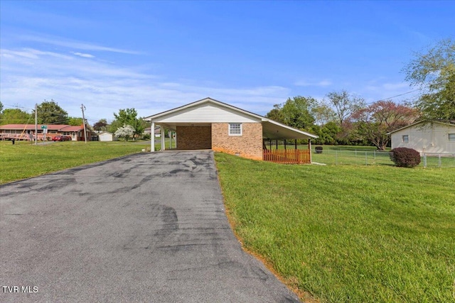 212 Mayflower Rd, Johnson City, TN 37601 - view of front of home featuring fence, driveway, a carport, brick siding, and a front yard