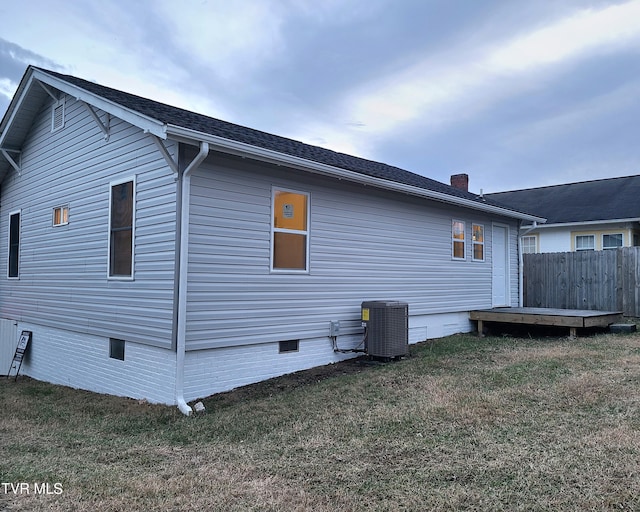 exterior space featuring a yard and cooling unit