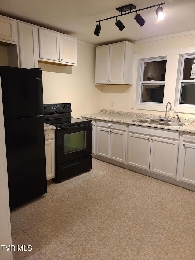 kitchen featuring rail lighting, ornamental molding, sink, black appliances, and white cabinetry