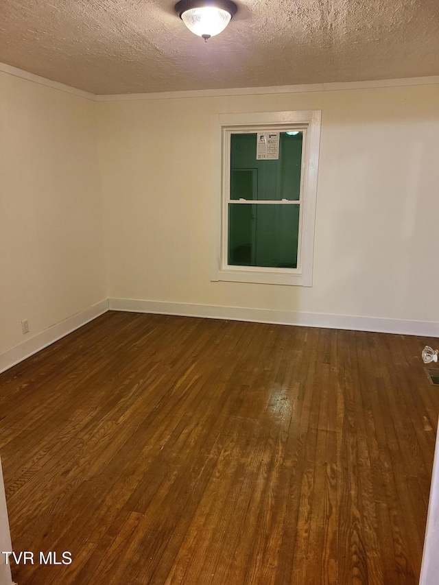 empty room with a textured ceiling and dark hardwood / wood-style floors