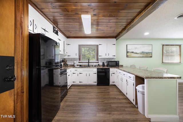 kitchen featuring black appliances, sink, kitchen peninsula, tasteful backsplash, and white cabinetry