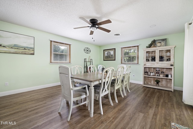 dining area featuring a textured ceiling, a wealth of natural light, dark wood-type flooring, and ceiling fan